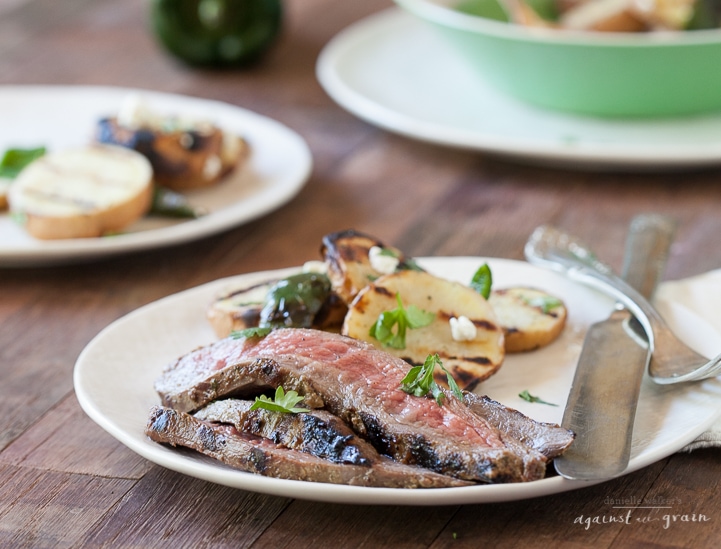 A plate of tasty Grilled Flank Steak with Cilantro Balsamic Marinade with grilled sweet potatoes and poblano peppers.