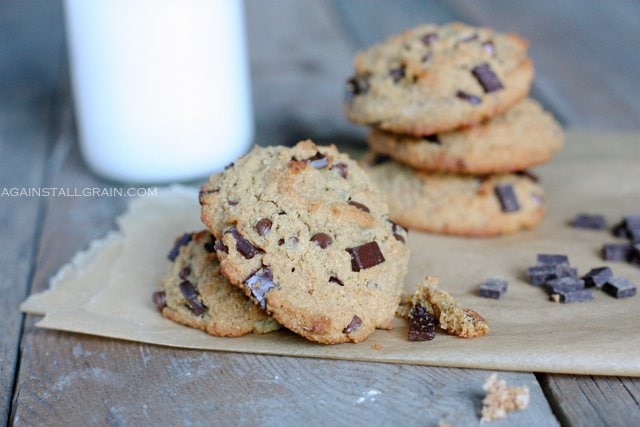 Nut Free 'Peanut' Butter Chocolate Chip Cookies piled high with a glass of milk.