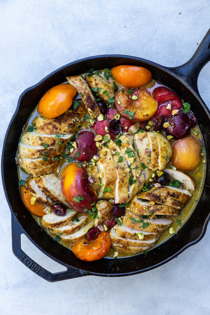 Roasted Chicken with Honey-Thyme Stone Fruits in a black cast iron skillet