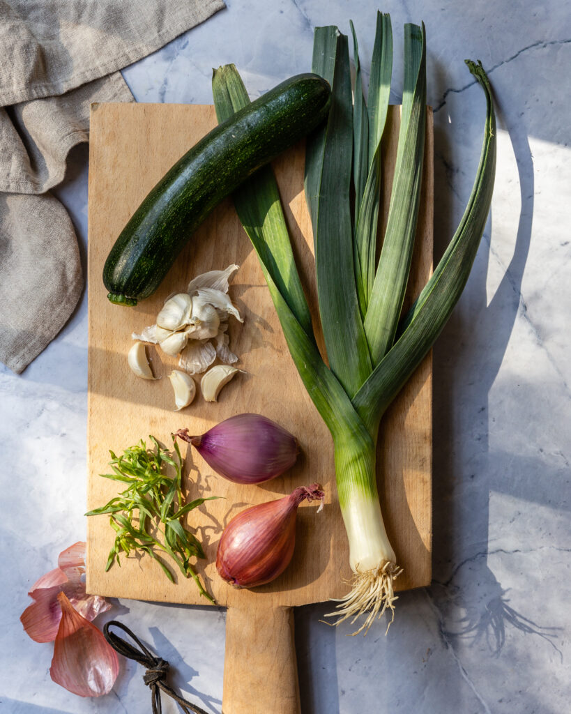 Variety of ingredients on a wooden cutting board in preparation to make lemon-crusted halibut