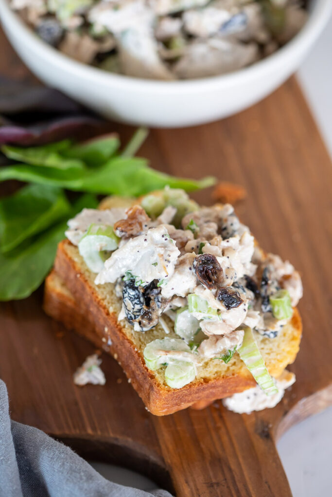 Leftover Turkey Salad on a grain free slice of bread on a wooden cutting board