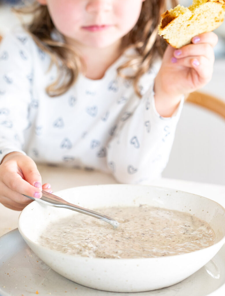 young child eating dairy-free cream of mushroom soup