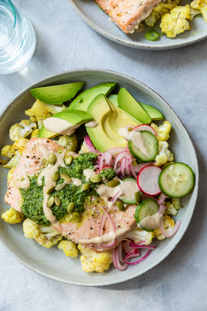 image of a cali salmon bowl on a counter with pickled veggies and cauliflower