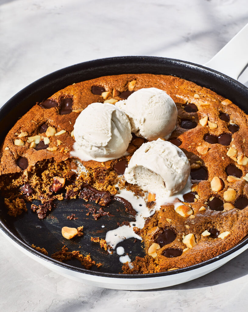 Chocolate Coffee Mac Nut Cookie Pie is photographed in a skillet on a white counter as part of Danielle Walker's go-to Gluten-Free Cookie Recipes