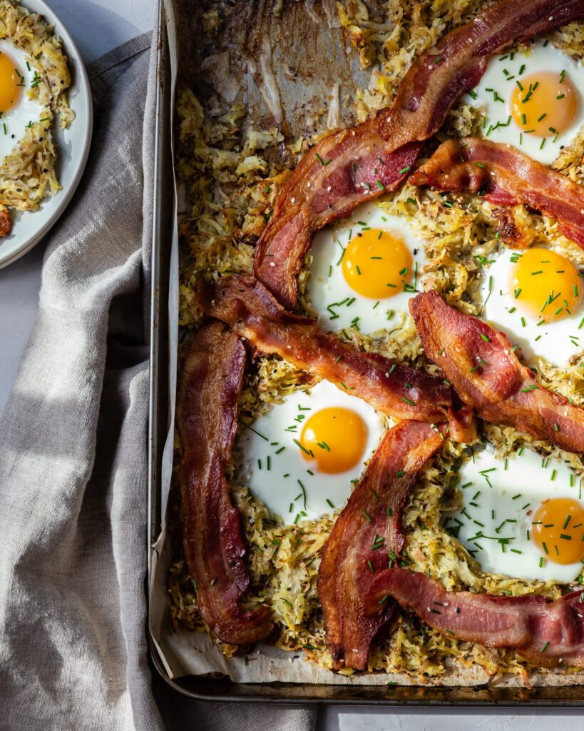 image of bacon, eggs, potatoes on a sheet tray