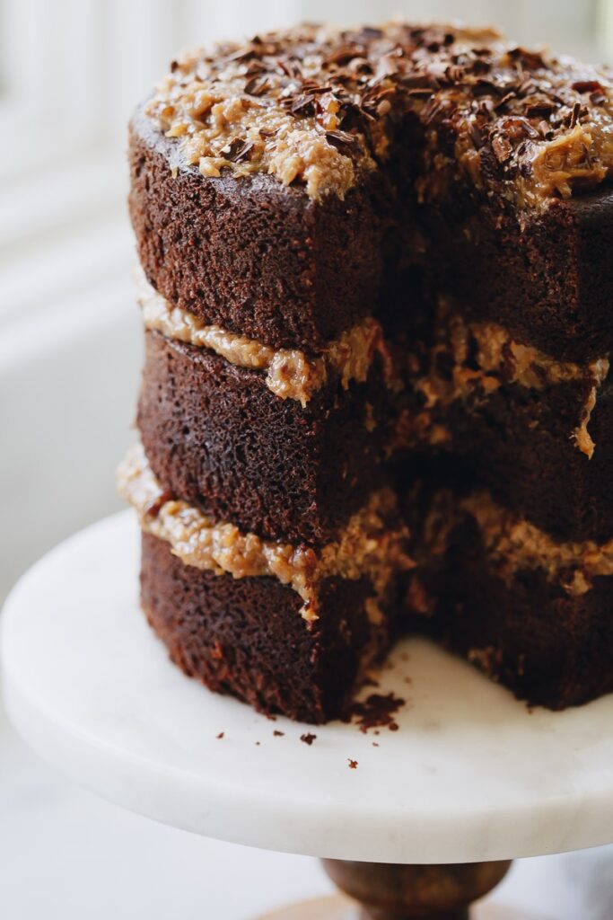 image of almond flour gluten free german chocolate cake on a cake stand. 