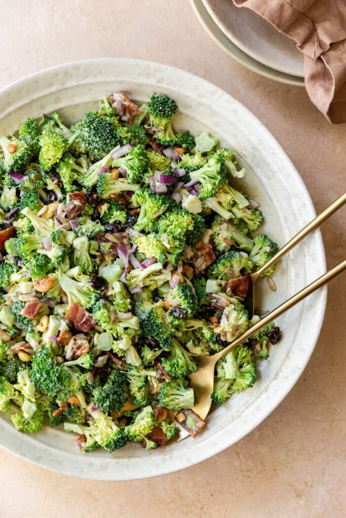close up image of broccoli crunch salad in a white bowl.