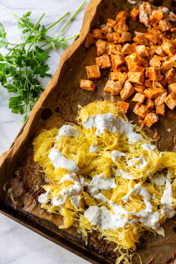 image of spaghetti squash and buffalo chicken on a sheet pan