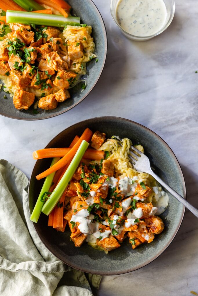 image of buffalo chicken spaghetti squash pasta in a gray bowl on a table