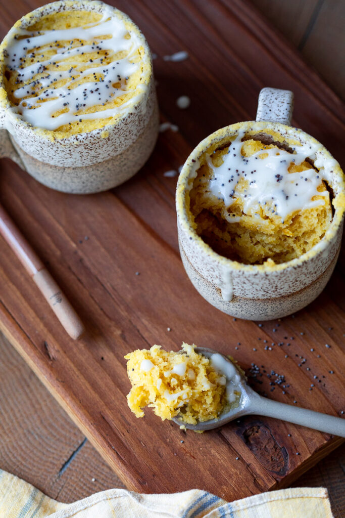 image of two gluten free lemon mug cakes one with a spoonful taken out