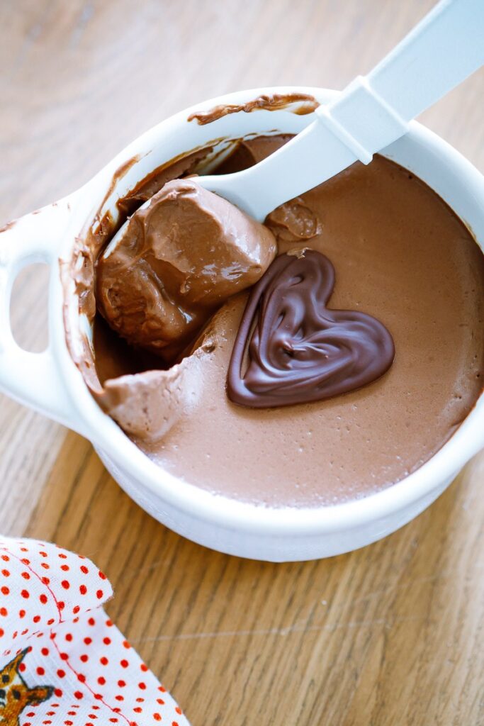 image of a bowl of dairy-free chocolate pot de creme with a spoon