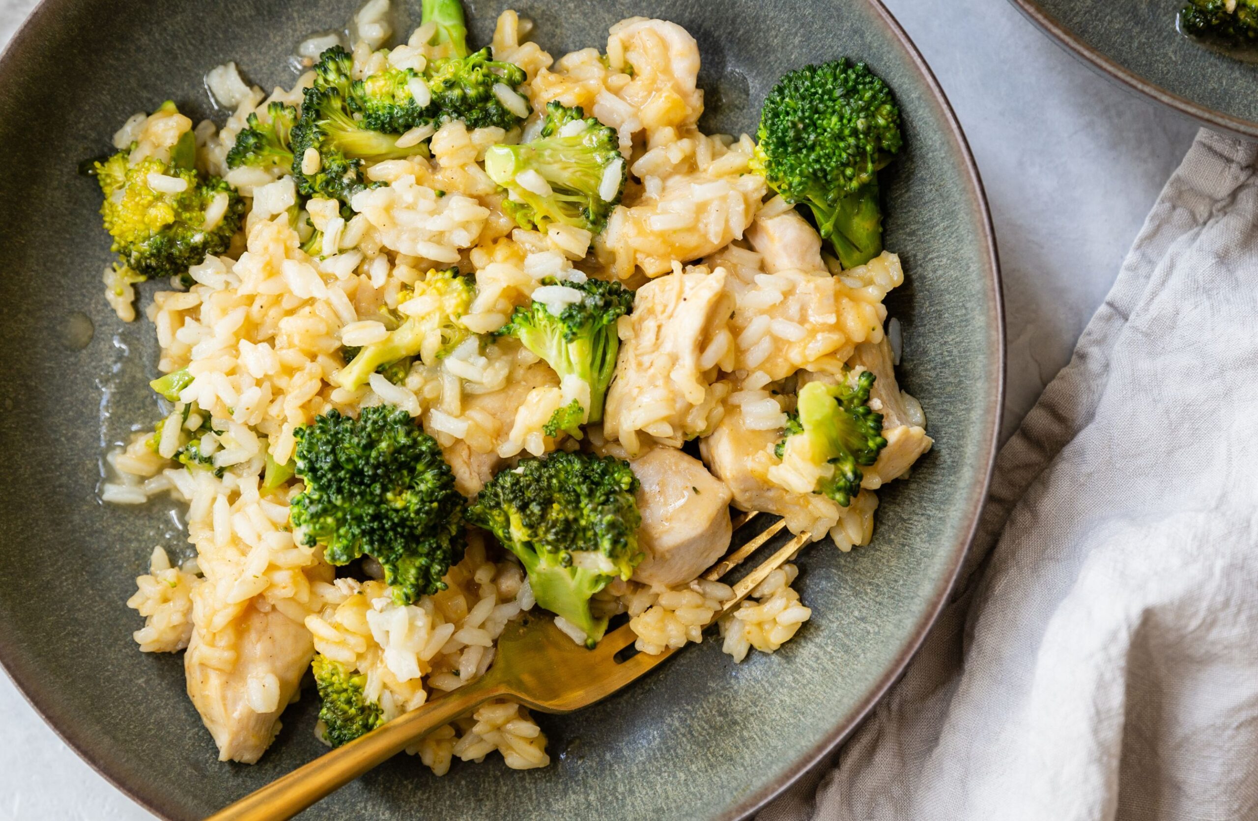 image of instant pot dairy free chicken broccoli rice casserole in a bowl on a countertop