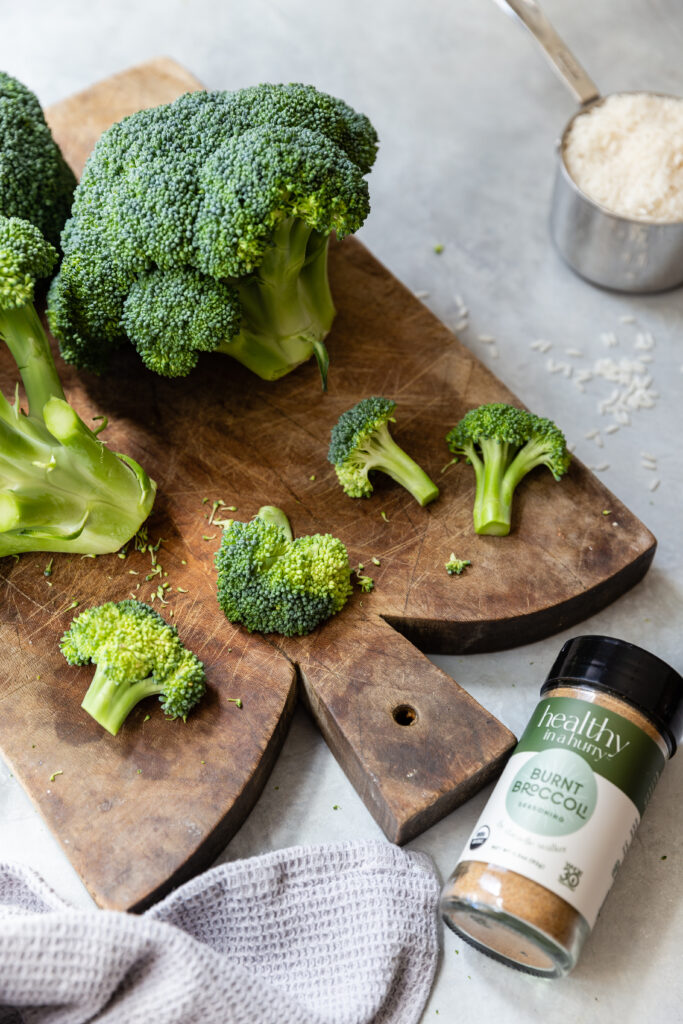 image of broccoli on a cutting board with burnt broccoli seasoning jar beside it