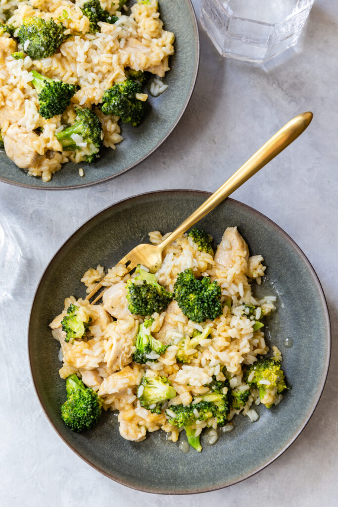 image of instant pot dairy free chicken broccoli rice casserole in a bowl with a spoon on a counter