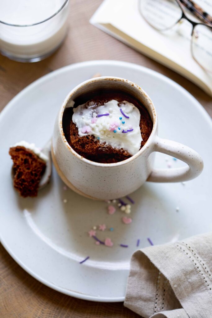 image of a chocolate gluten free mug cake with a bite in the spoon