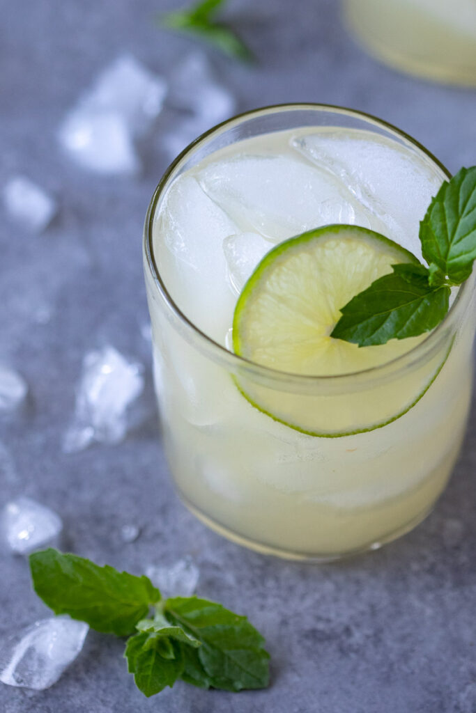 image close up of a mojito mocktail in a clear glass with mint and lime