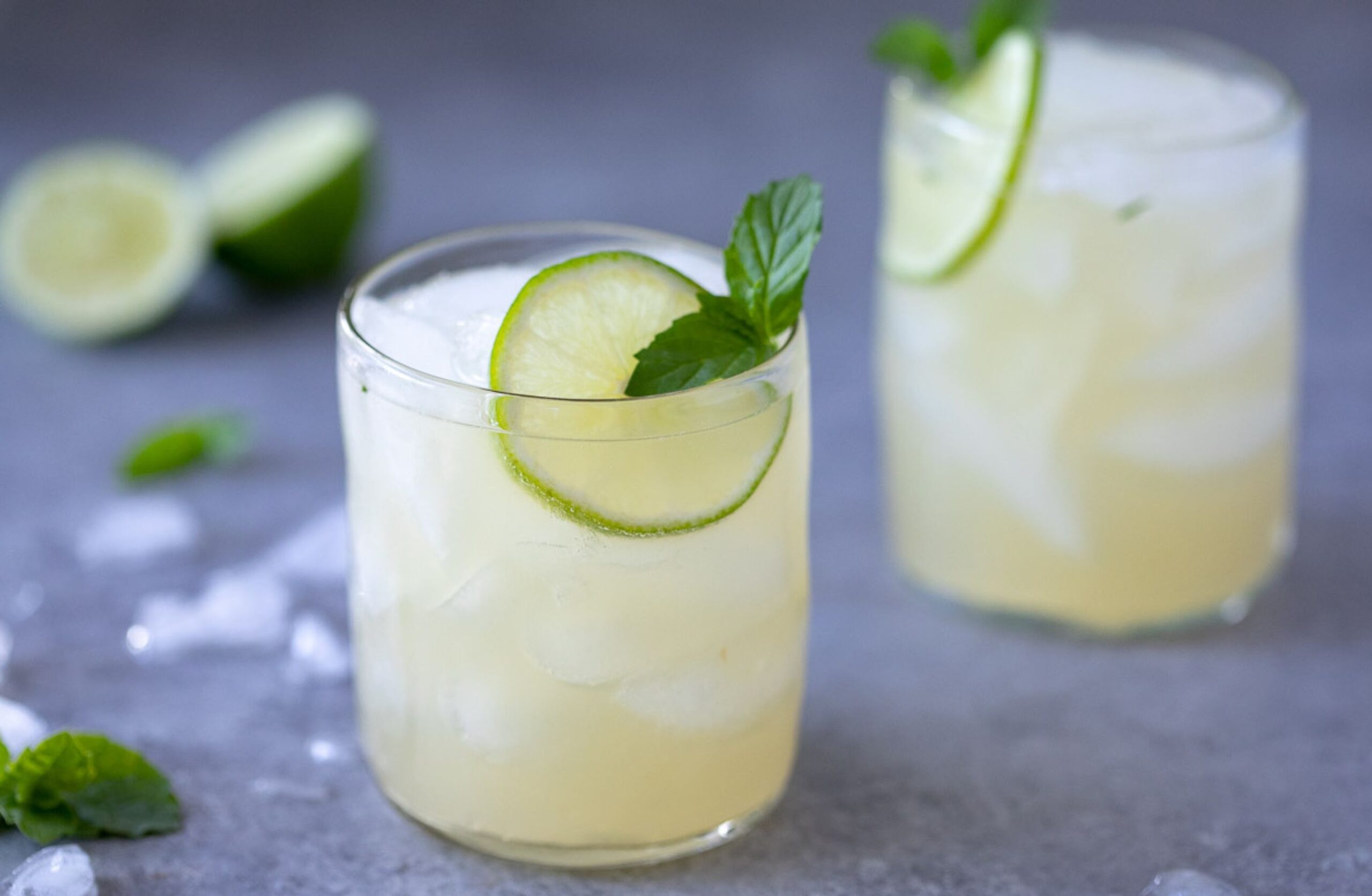 image of two glasses of mojito mocktails with lime and mint