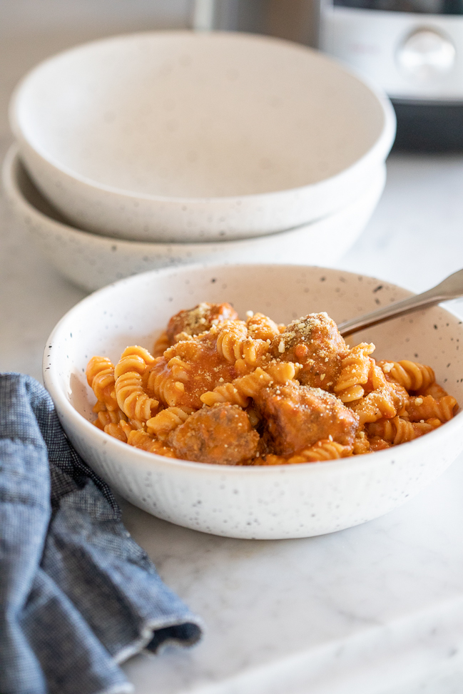 image of instant pot spaghetti and meatballs in a white bowl on a counter