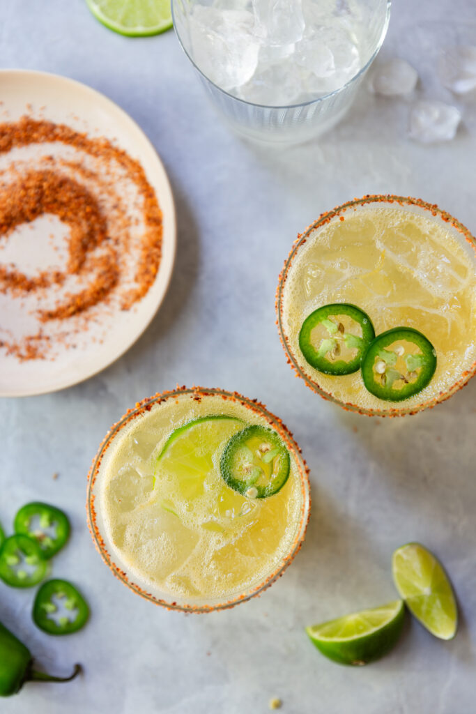 image of two glasses of margarita mocktails with jalapeno slices in them