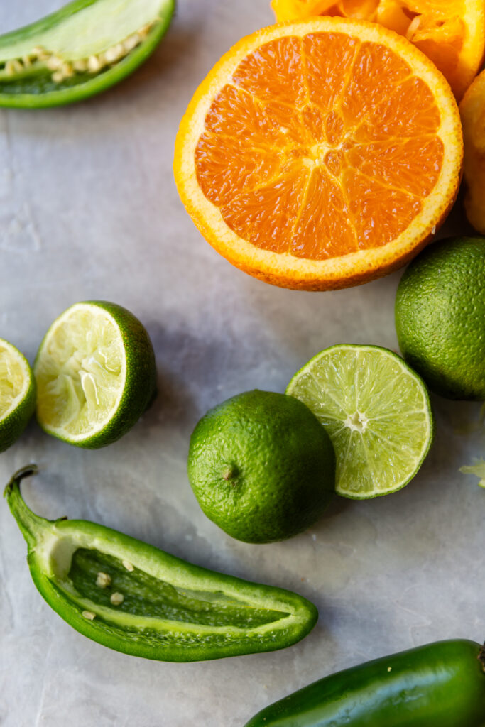 image of orange, lime, and jalapenos on a counter